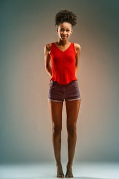 Her posture and bright smile communicate a vibrant, assertive personality