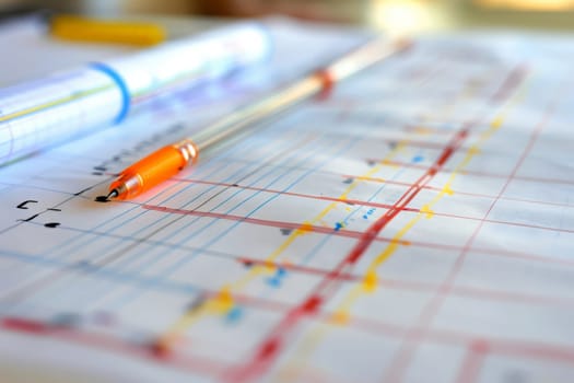 Close-up view of a detailed project blueprint with annotations and colorful lines.