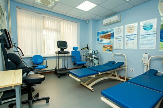 A hospital room adorned with serene blue chairs and state-of-the-art medical equipment, creating an atmosphere of peace and comfort.