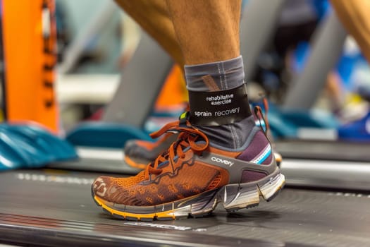 A focused person in motion, running vigorously on a treadmill.