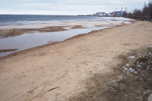 Petrozavodsk, Russia 04.14.24 Ice drift in spring Lake Onega, Karelia. Port and berths for ships. Aggregate accumulations of fine-crystalline grains. Opening of small lakes, ponds. Crushed ice floes.