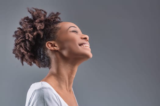Exhilarating joy lights up the young woman's features, her head thrown back in a moment of pure happiness
