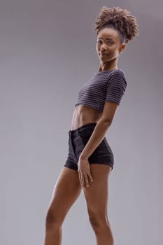Playful side glance, contemporary outfit, youthful vibe