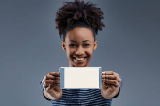 Enthusiastically holding a smartphone, the woman's cheerful demeanor suggests endless possibilities in technology