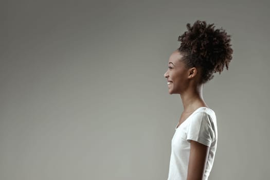 young woman's face radiates happiness as she reacts to a delightful moment, her joy unmistakable