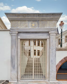 Marble gateway leads into historical Ottoman architecture Arnavutkoy Tevfikiye Mosque, adorned with intricate Ottoman inscriptions, Istanbul, Turkey. The mosque was built in the 18th century