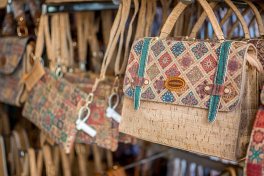 Vila Real de Santo Antonio, Portugal, April 13th 2024: Illustrative Editorial: View on Portugal cork handbags, product in the Algarve for sale in a shop as tourist souvenir.