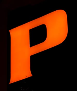 Fluorescent orange 'P' letter glows vibrantly against a shadowy backdrop, encapsulating power and presence
