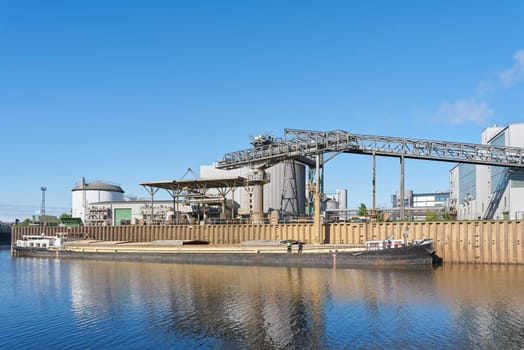 Loading a ship with rapeseed meal, a by-product of the extraction of rapeseed oil from rapeseed, at an oil mill in the port of Magdeburg