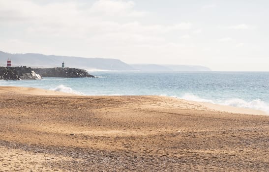 Photography taken on Praia da Nazaré beach with rough sea in Portugal, soft colors
