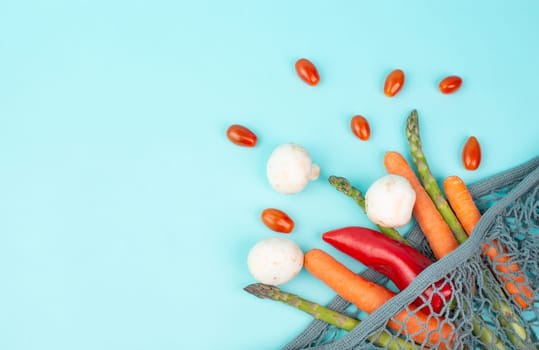 Asparagus sprout, mushrooms, carrots and tomatoes, zero waste, mesh bag with vegetables, shopping grocery, healthy food ingredients