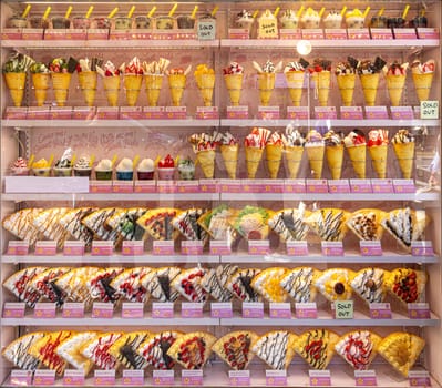TOKYO/JAPAN - November 21, 2023:Shop window with multitude of crepes in various flavours