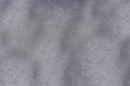 Grey textile background with a rough wavy surface