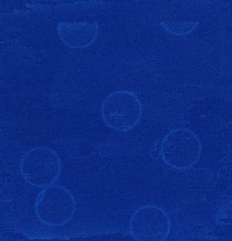 A blue abstract close-up structure with a circular pattern and streaks on the surface