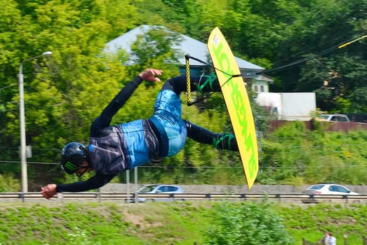 Russia, Volgodonsk - June 18, 2015: Water snowboard. The athlete with snowboard hold on to the rope and the boat accelerates.