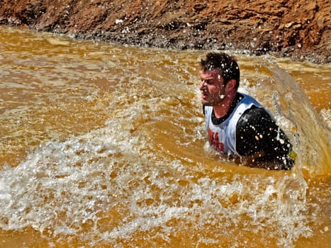 Obstacle. Man overcomes a large puddle.