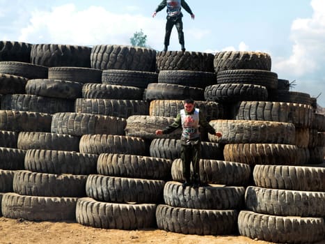 Athletes overcome a bunch of tires.