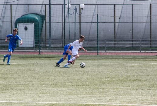 Russia, Volgodonsk - may 17, 2015: Football game. Training matches junior teams and fans