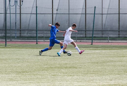 Russia, Volgodonsk - may 17, 2015: Football game. Training matches junior teams and fans