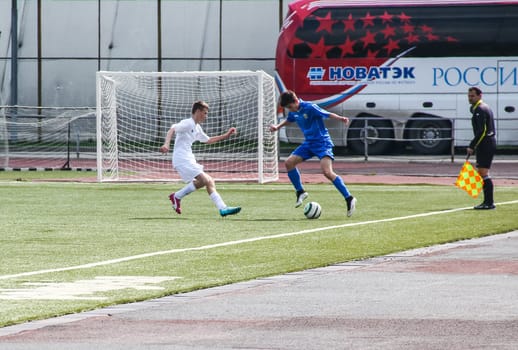 Russia, Volgodonsk - may 17, 2015: Football game. Training matches junior teams and fans