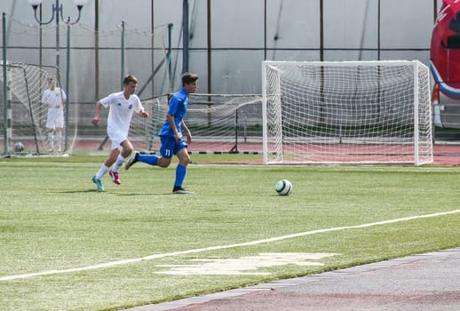 Russia, Volgodonsk - may 17, 2015: Football game. Training matches junior teams and fans