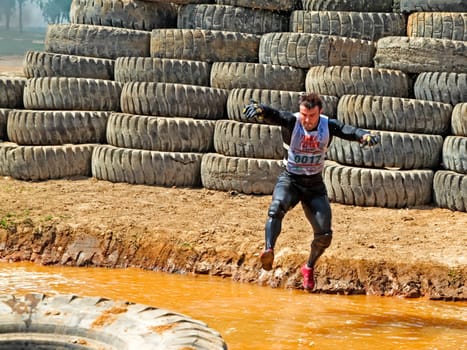 Obstacle. Man overcomes a large puddle.