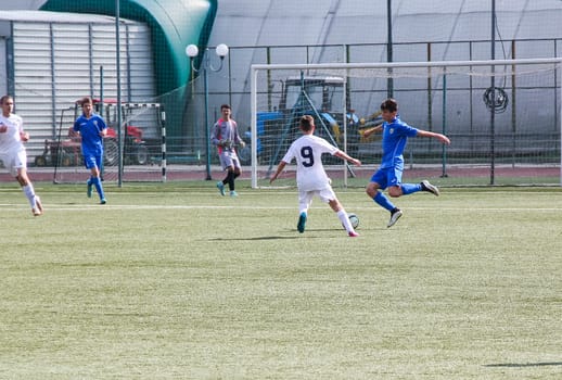 Russia, Volgodonsk - may 17, 2015: Football game. Training matches junior teams and fans