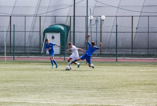 Russia, Volgodonsk - may 17, 2015: Football game. Training matches junior teams and fans