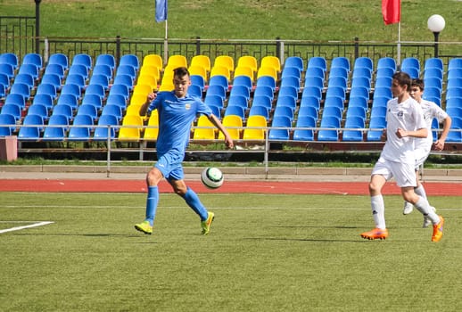 Russia, Volgodonsk - may 17, 2015: Football game. Training matches junior teams and fans