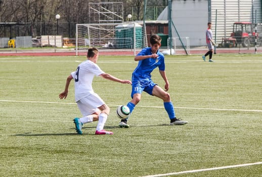 Russia, Volgodonsk - may 17, 2015: Football game. Training matches junior teams and fans