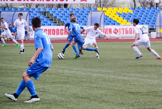 Russia, Volgodonsk - may 17, 2015: Football game. Training matches junior teams and fans