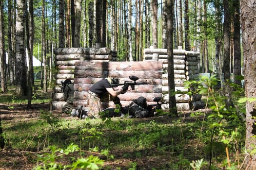 Russia, Volgodonsk - June 30, 2015: Paintball. Shooting competition of weapons with paint balls. Forest tournament