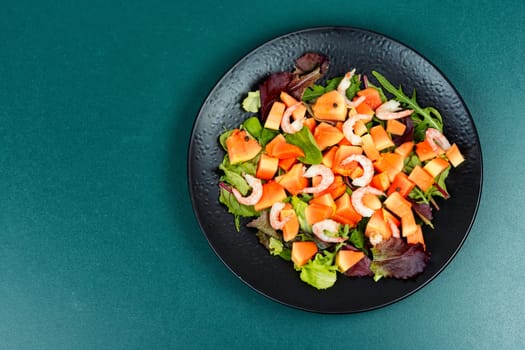 Salad with fresh papaya, shrimp, prawns and greens. Thai food.