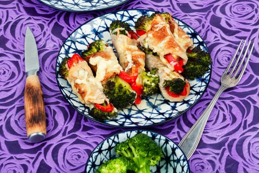 Meat rolls or roulades stuffed with broccoli and peppers. Meat with vegetable filling.