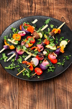 Vegetable juicy skewers, grilled vegetables or barbecue vegetables on wooden skewers. Summer barbecue food.