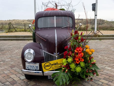 Noordwijk, Netherlands - April 22, 2023: Cars decorated with flowers taking part in the Bloemencorso Bollenstreek the annual spring flower parade from Noordwijk to Haarlem in the Netherlands.