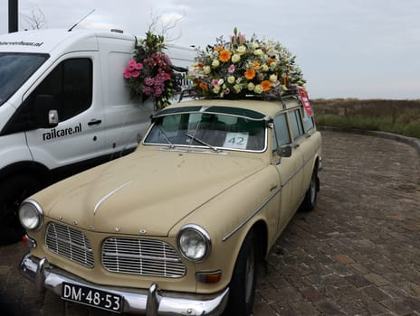 Noordwijk, Netherlands - April 22, 2023: Cars decorated with flowers taking part in the Bloemencorso Bollenstreek the annual spring flower parade from Noordwijk to Haarlem in the Netherlands.