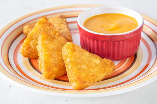Hash Browns patties with cheddar cheese sauce