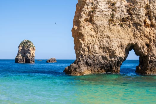 Balanced complementary symmetry of rocks at a heavenly beach photographed near Portimão, Algarve, Portugal
