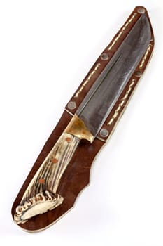 Hunting knife with antler handle. Selective focus with shallow depth of field.