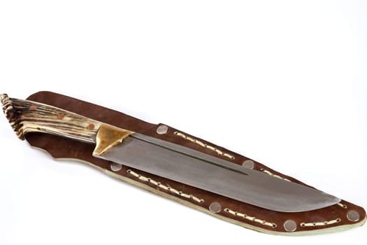 Hunting knife with antler handle. Selective focus with shallow depth of field.
