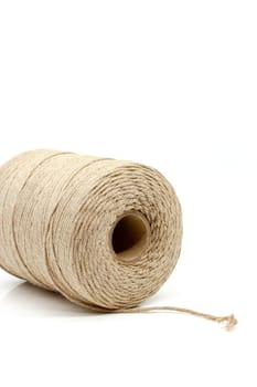 A spool of natural cotton twine with a wide range of applications. Selective focus with shallow depth of field.