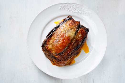 Close up of a plate of rustic italian eggplant parmigiana