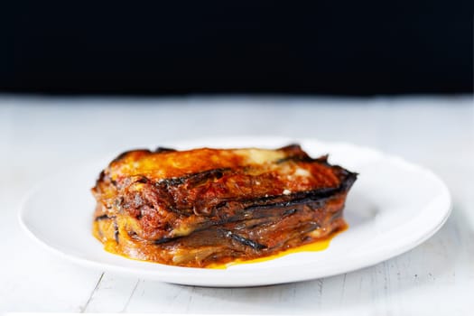 Close up of a plate of rustic italian eggplant parmigiana