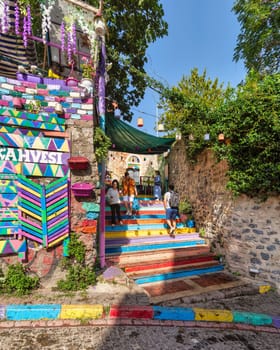 Istanbul, Turkey - August 28 2022: Tourists visiting famous traditional cafe decorated with multicolored panels and colorful stairs, suited in Balat District