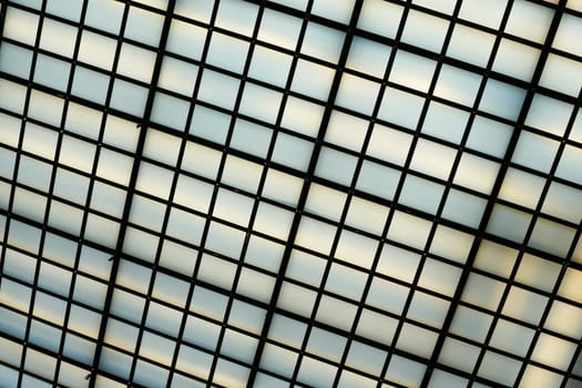 Ceiling construction of an office building with many glass panes to capture daylight