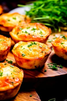 Close-up of a plate with small tartlets and greens