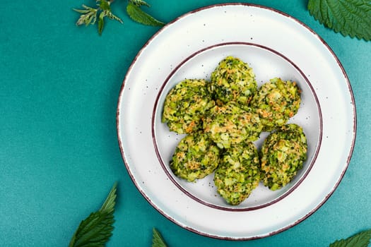 Vegetarian cutlets of cutlet nettles leaves and broccoli. Fried nettle meat balls on wooden rustic table