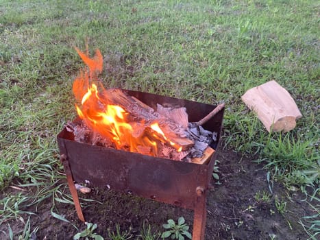 The barbecue grill is lit for the cooking outdoors