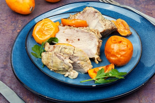 Roasted barbecue tenderloin meat with succulent loquat fruits. Delicious piece of meat roasted with ripe medlar fruit